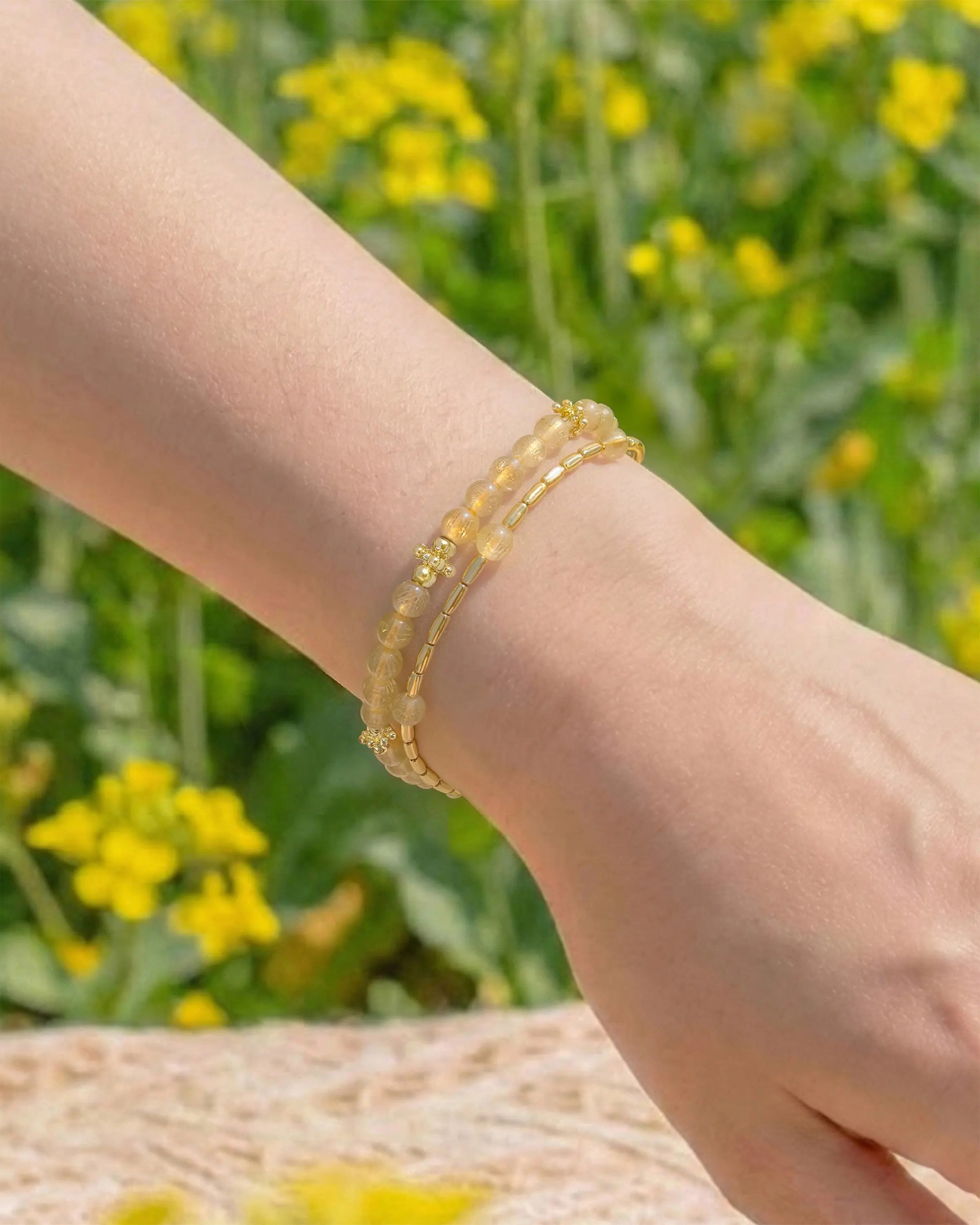 Golden Rutilated Quartz Gold Floral pre-layered bracelet on the model's wrist