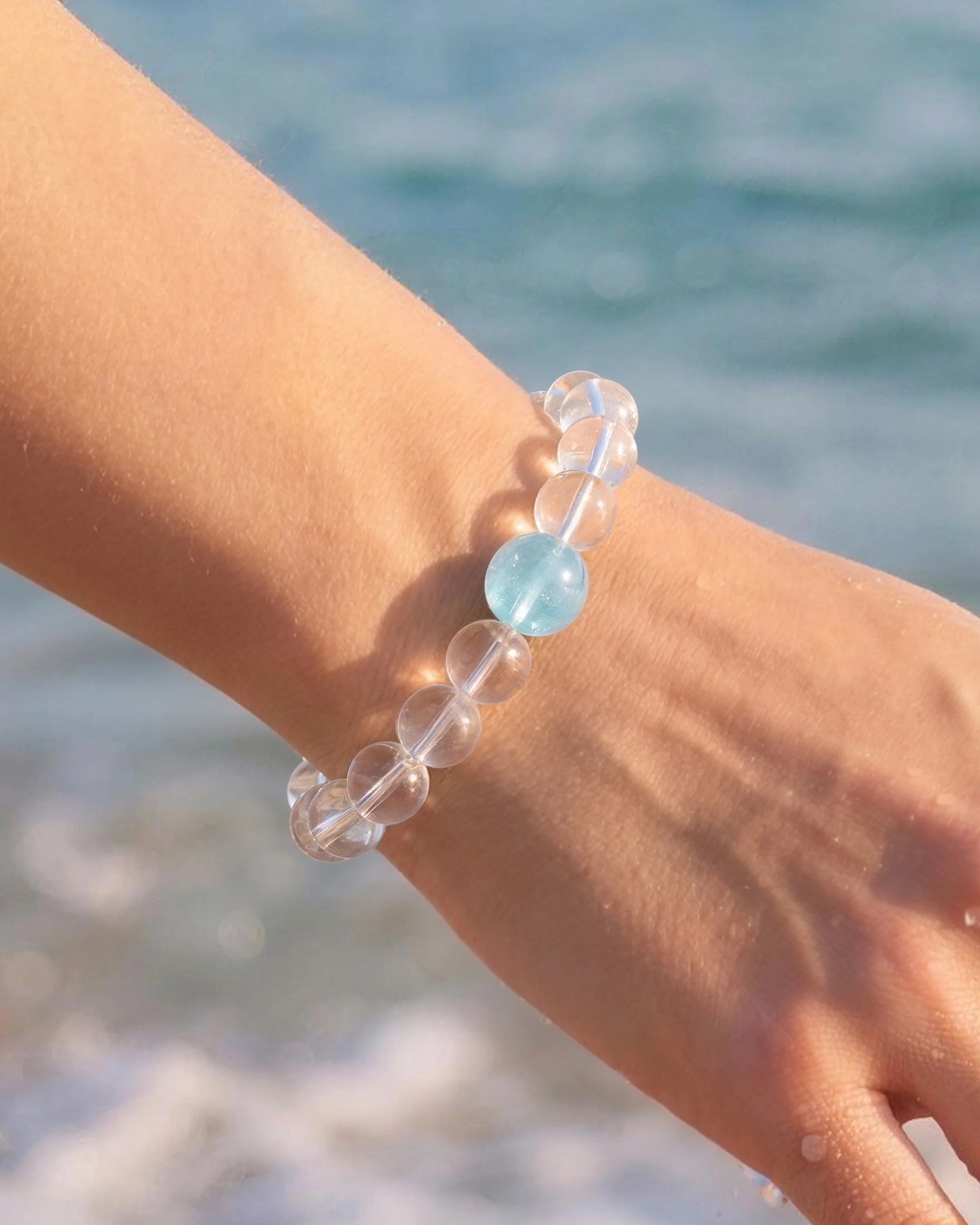 Close-up of Ocean Drop Clear Quartz Aquamarine Bracelet on wrist