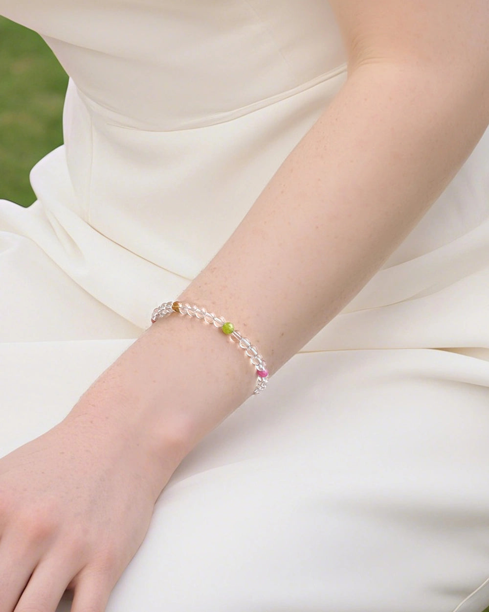model wearing clear quartz beaded bracelet with multi-gem