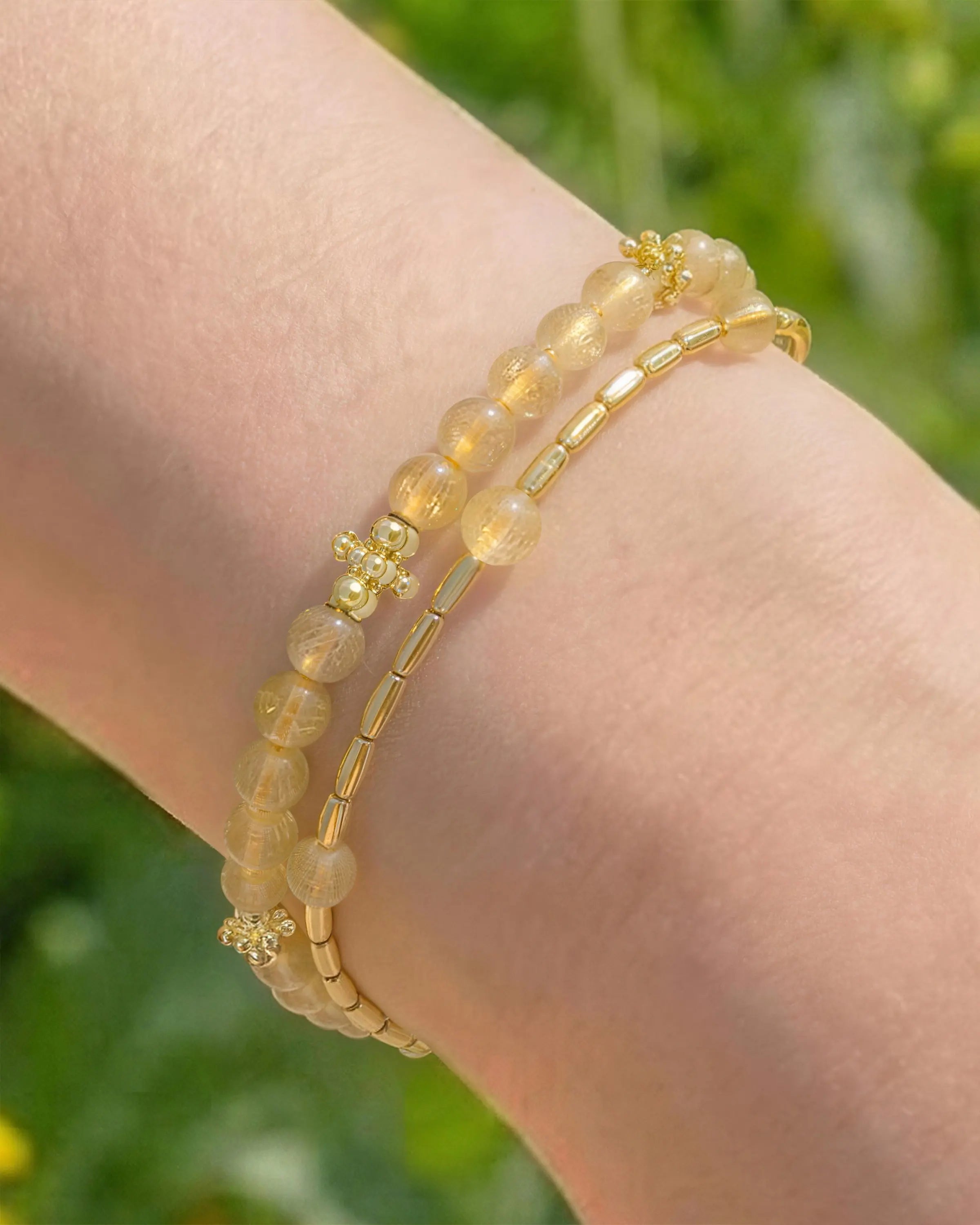Golden Rutilated Quartz Gold Floral pre-layered bracelet on the model's wrist
