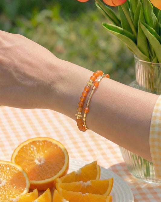 Orange Agate Gold Floral pre-layered bracelet on the model's wrist